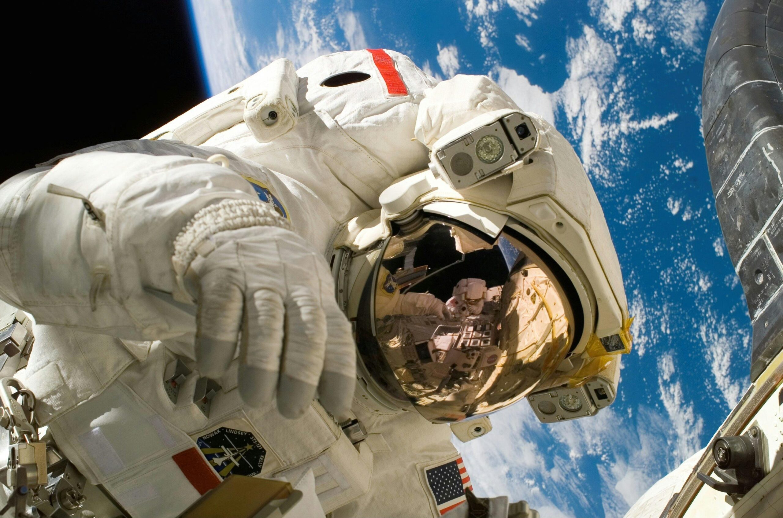 An astronaut (wearing a suit) floating above earth.